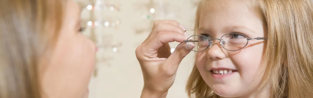 A child having her spectacle frames fitted